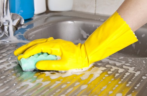 Local cleaners preparing a kitchen and cupboards in Holland Park